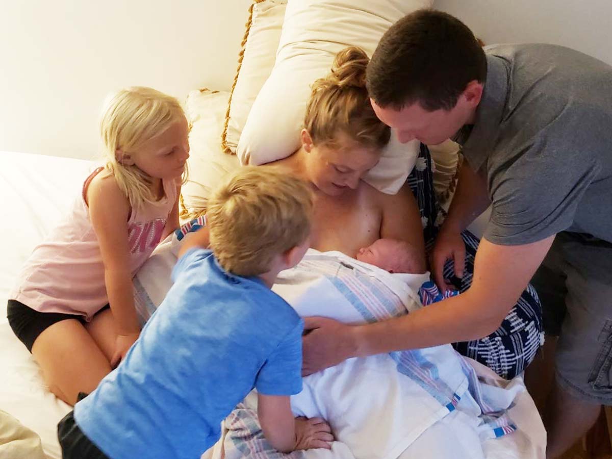 Nicole and family hold their new baby